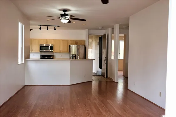 a view of a kitchen with a sink dishwasher oven window and wooden floor