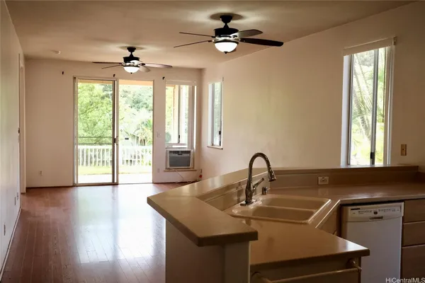 a kitchen with a sink a window and a chandelier
