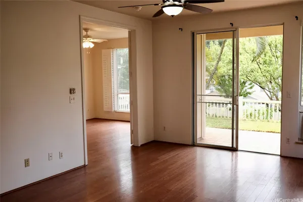 a view of a livingroom with wooden floor and a window