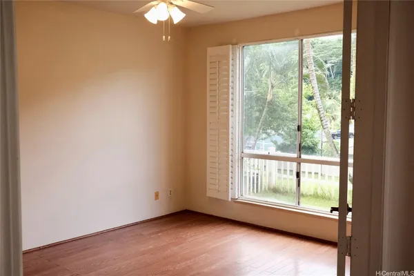 a view of a room with wooden floor and windows