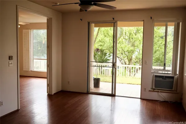 a view of a room with wooden floor and a window