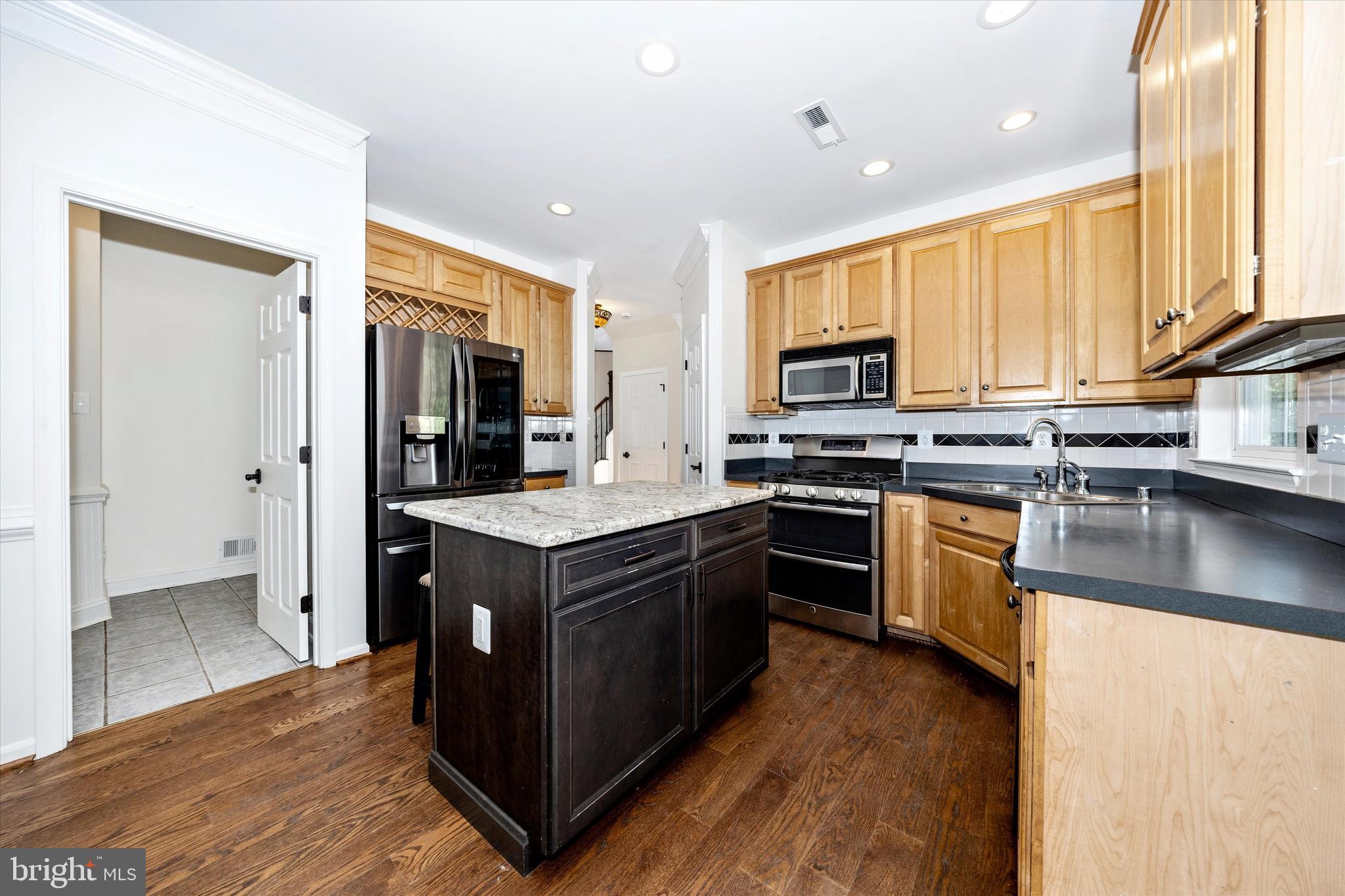 803 Apache Court Frederick, MD 21701 - Photo 10 of 46 a kitchen with stainless steel appliances granite countertop a stove a sink and a refrigerator