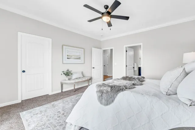 a bedroom with a large bed and a chandelier