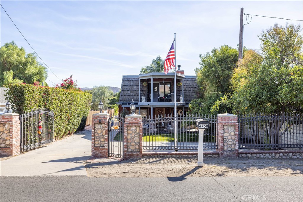 4750 Adam Road Simi Valley, CA 93063 - Photo 1 of 1 a view of a wooden house with a small yard and large trees