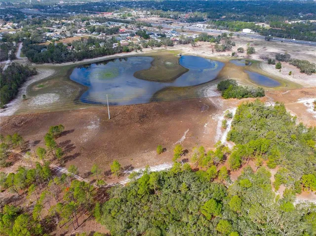 an aerial view of residential houses with outdoor space and seating