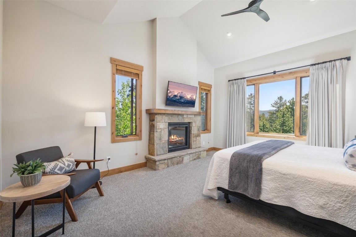 41 Barton Ridge Drive Breckenridge, CO 80424 - Photo 16 of 42 a spacious bedroom with a bed and a fireplace