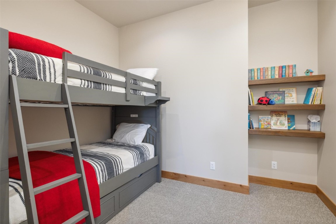 41 Barton Ridge Drive Breckenridge, CO 80424 - Photo 17 of 42 a bedroom with a bed and a book shelf