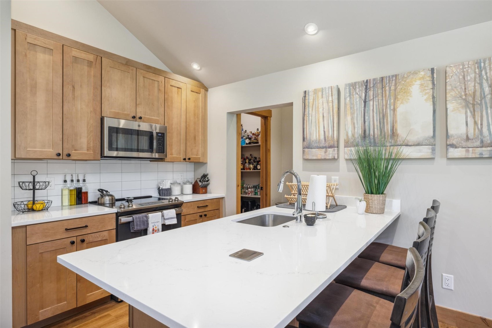 41 Barton Ridge Drive Breckenridge, CO 80424 - Photo 36 of 47 a kitchen with stainless steel appliances a sink a microwave a refrigerator and cabinets