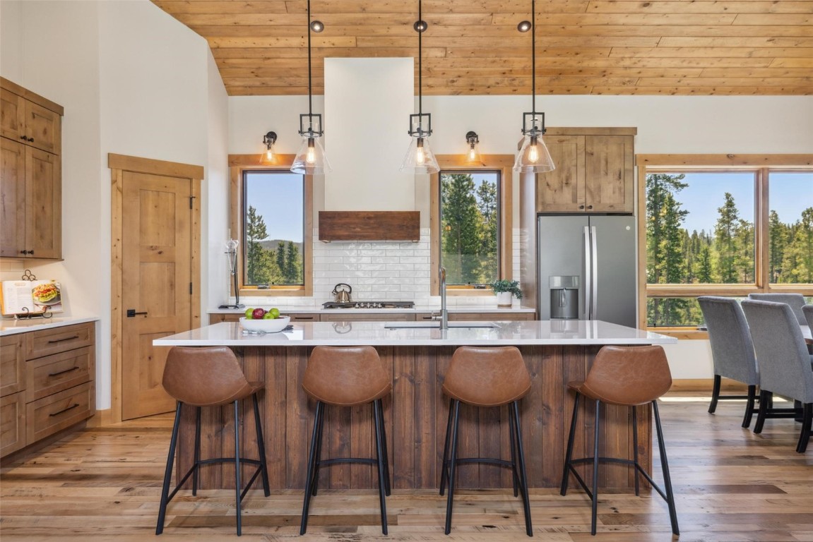 41 Barton Ridge Drive Breckenridge, CO 80424 - Photo 8 of 42 a kitchen with a table chairs stove and wooden floor