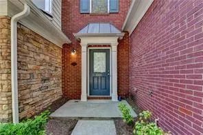 a view of a brick house with a large window