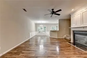a view of an empty room with a fireplace and a window