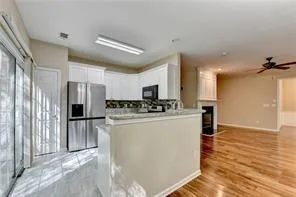 a view of kitchen with refrigerator stove microwave and cabinets