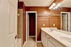 a bathroom with a double vanity sink and mirror