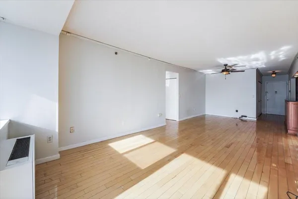 a view of a room with wooden floor