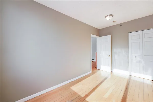 a view of a room with wooden floor