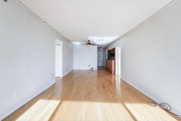 a view of hallway with wooden floor