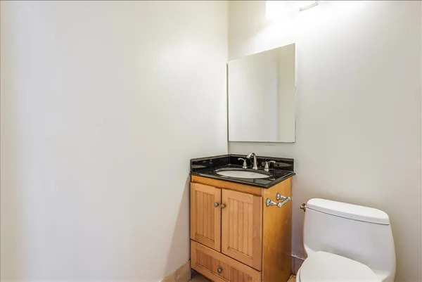 a bathroom with a stove a sink and a microwave