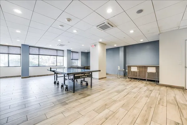a view of a room with furniture and wooden floor
