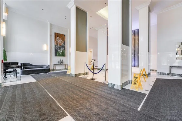 a view of living room filled with furniture and floor to ceiling window