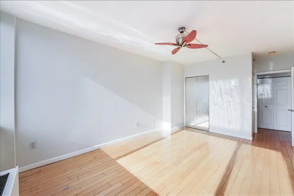 a view of a room with wooden floor