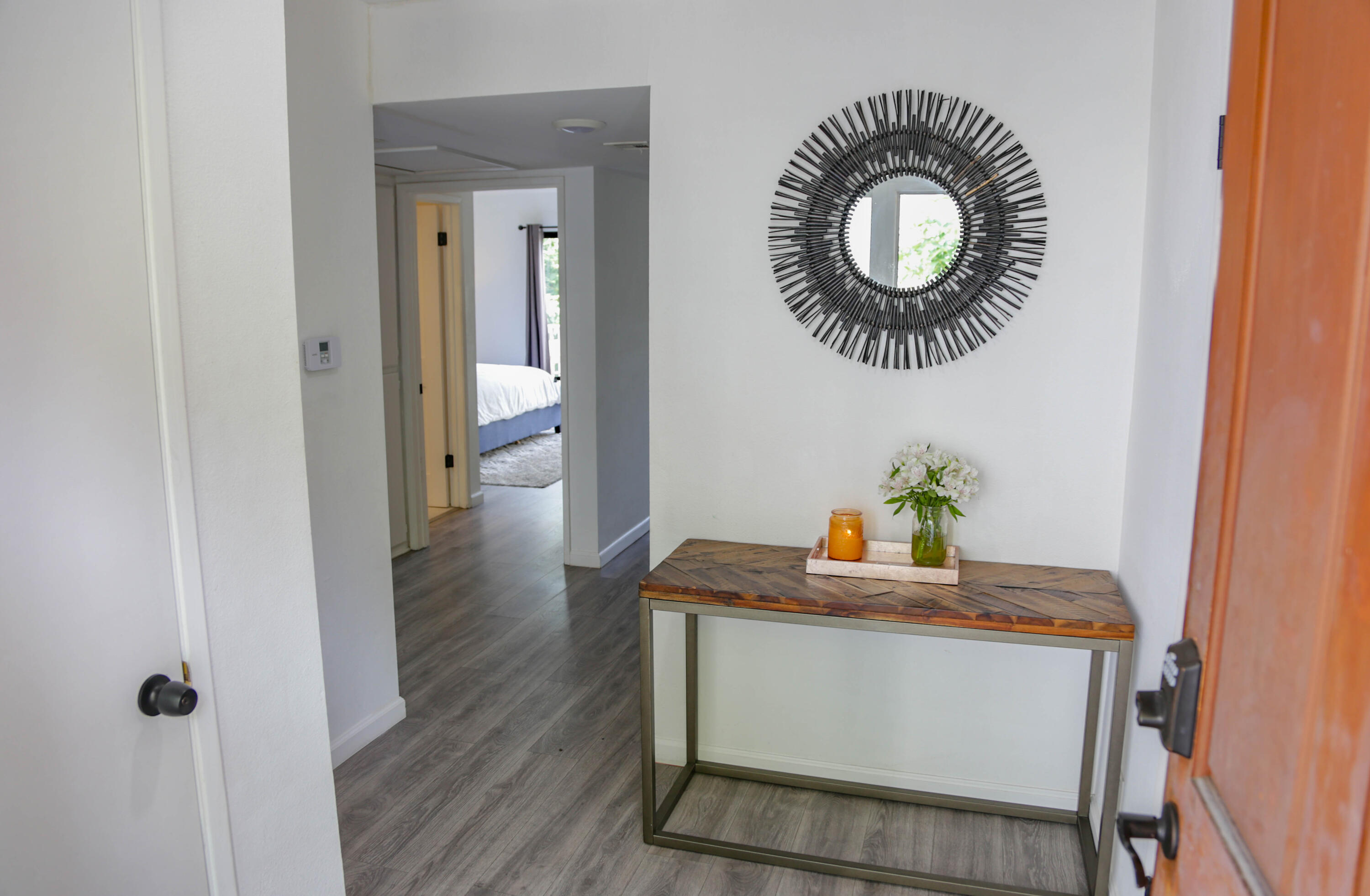 a dining room with furniture and mirror