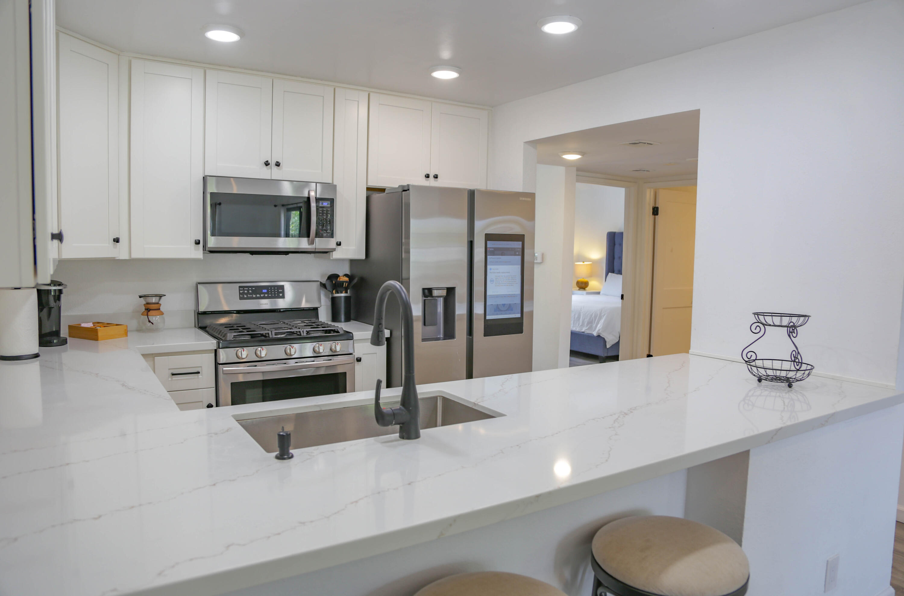 325 Ladera Street, Unit 5 Santa Barbara, CA 93101 - Photo 9 of 16 a kitchen with stainless steel appliances a refrigerator sink and microwave