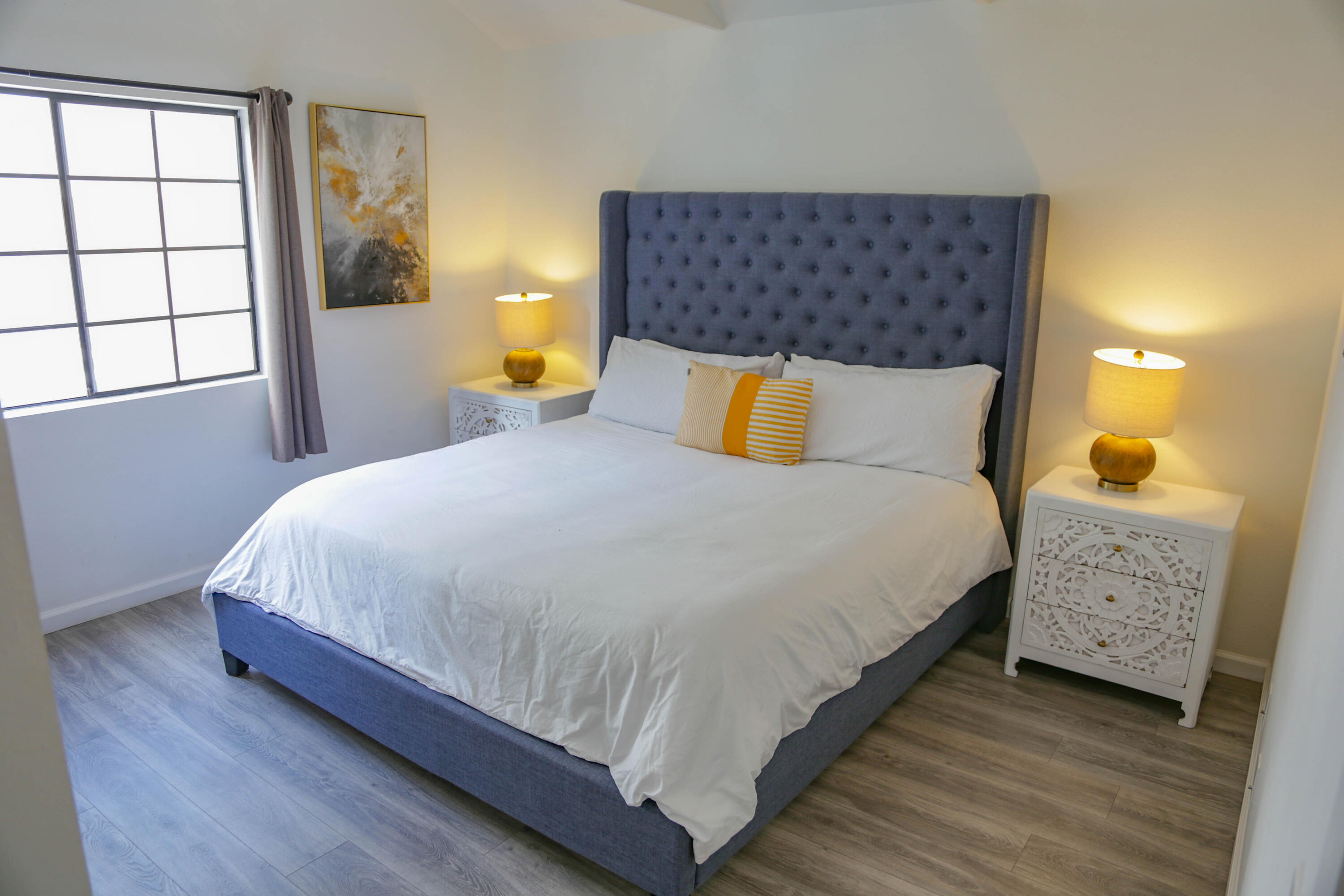 325 Ladera Street, Unit 5 Santa Barbara, CA 93101 - Photo 10 of 16 a large bed sitting in a bedroom next to a window