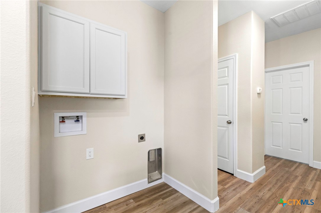 1628 Armstrong Street Luling, TX 78648 - Photo 17 of 23 a view of an empty room with wooden floor and closet