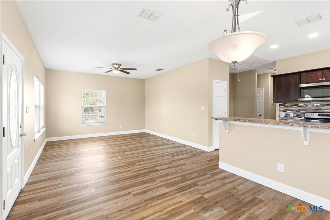 1628 Armstrong Street Luling, TX 78648 - Photo 8 of 23 a view of a kitchen with wooden floor and a kitchen