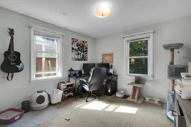 a view of a livingroom with workspace and a window