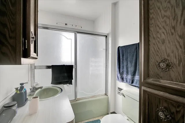 a bathroom with a sink toilet and shower