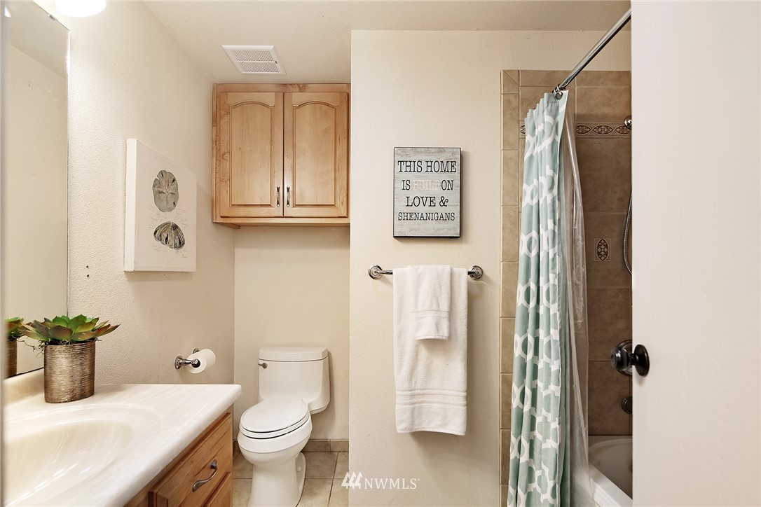 22605 1st Drive Southeast Bothell, WA 98021 - Photo 11 of 27 a bathroom with a granite countertop sink toilet and shower