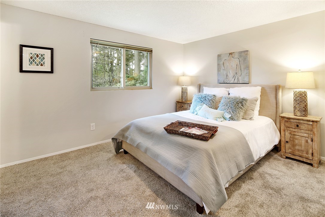 22605 1st Drive Southeast Bothell, WA 98021 - Photo 13 of 27 a bedroom with a bed and a lamp on dresser