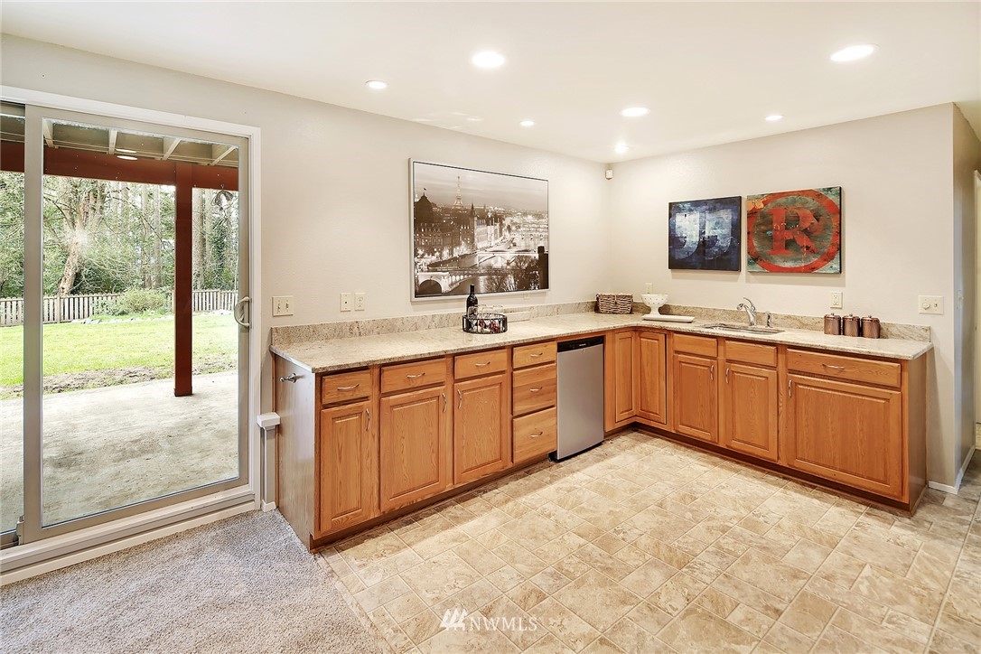 22605 1st Drive Southeast Bothell, WA 98021 - Photo 21 of 27 a kitchen with a sink stove and cabinets
