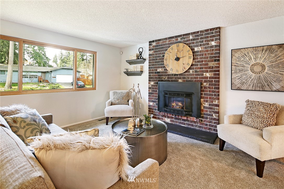 22605 1st Drive Southeast Bothell, WA 98021 - Photo 4 of 27 a living room with furniture a fireplace and a large window
