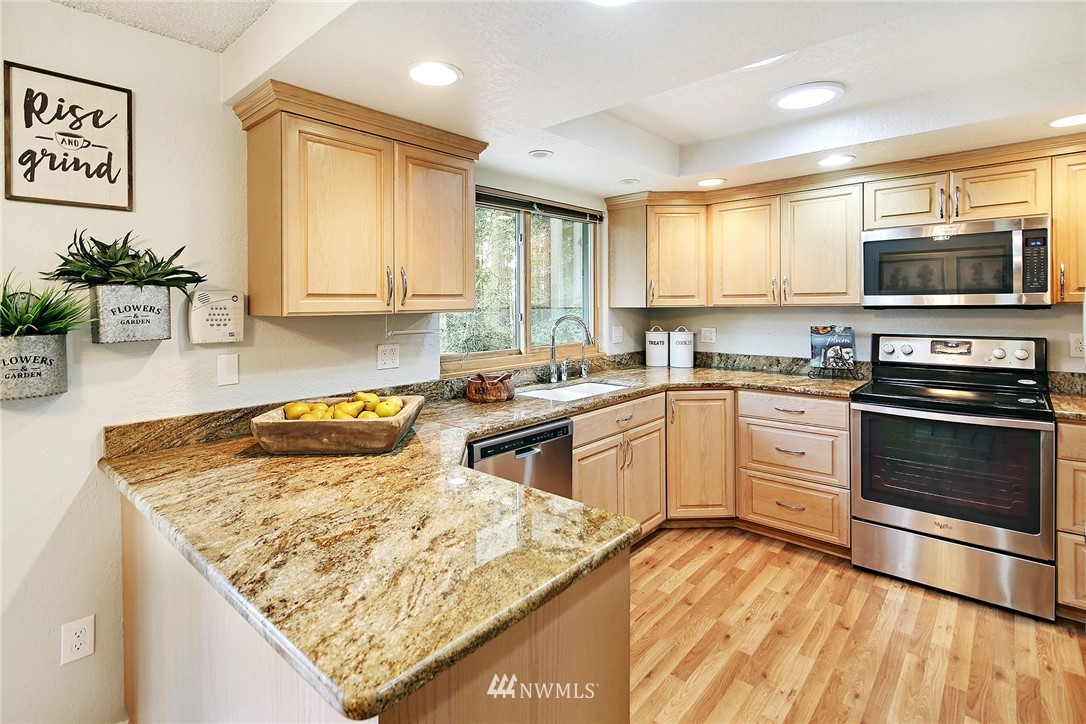 22605 1st Drive Southeast Bothell, WA 98021 - Photo 6 of 27 a kitchen with stainless steel appliances granite countertop a stove a sink and a microwave