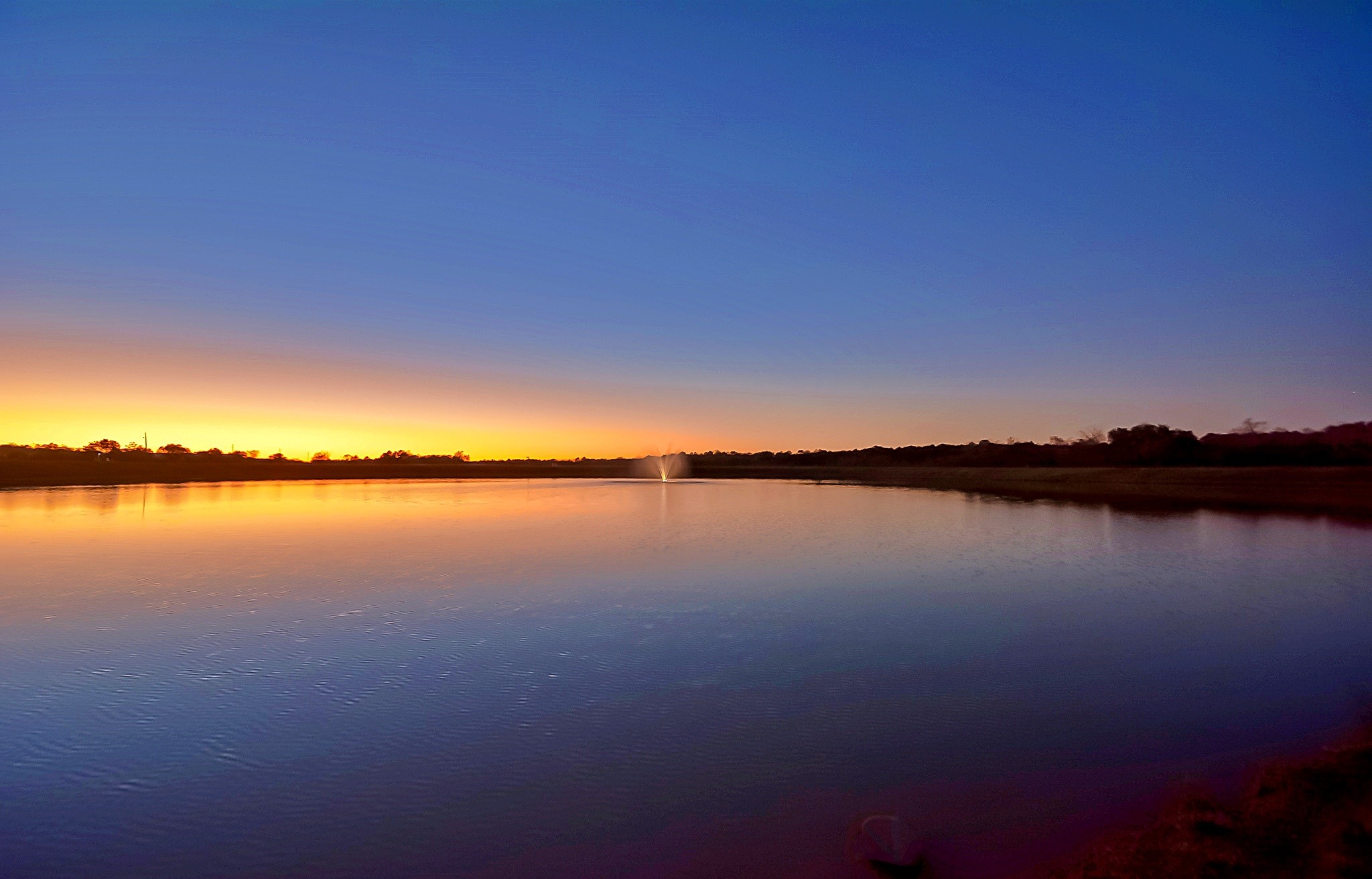 20719 Tealpointe Ridge Lane Tomball, TX 77377 - Photo 7 of 7 a view of lake and sunset