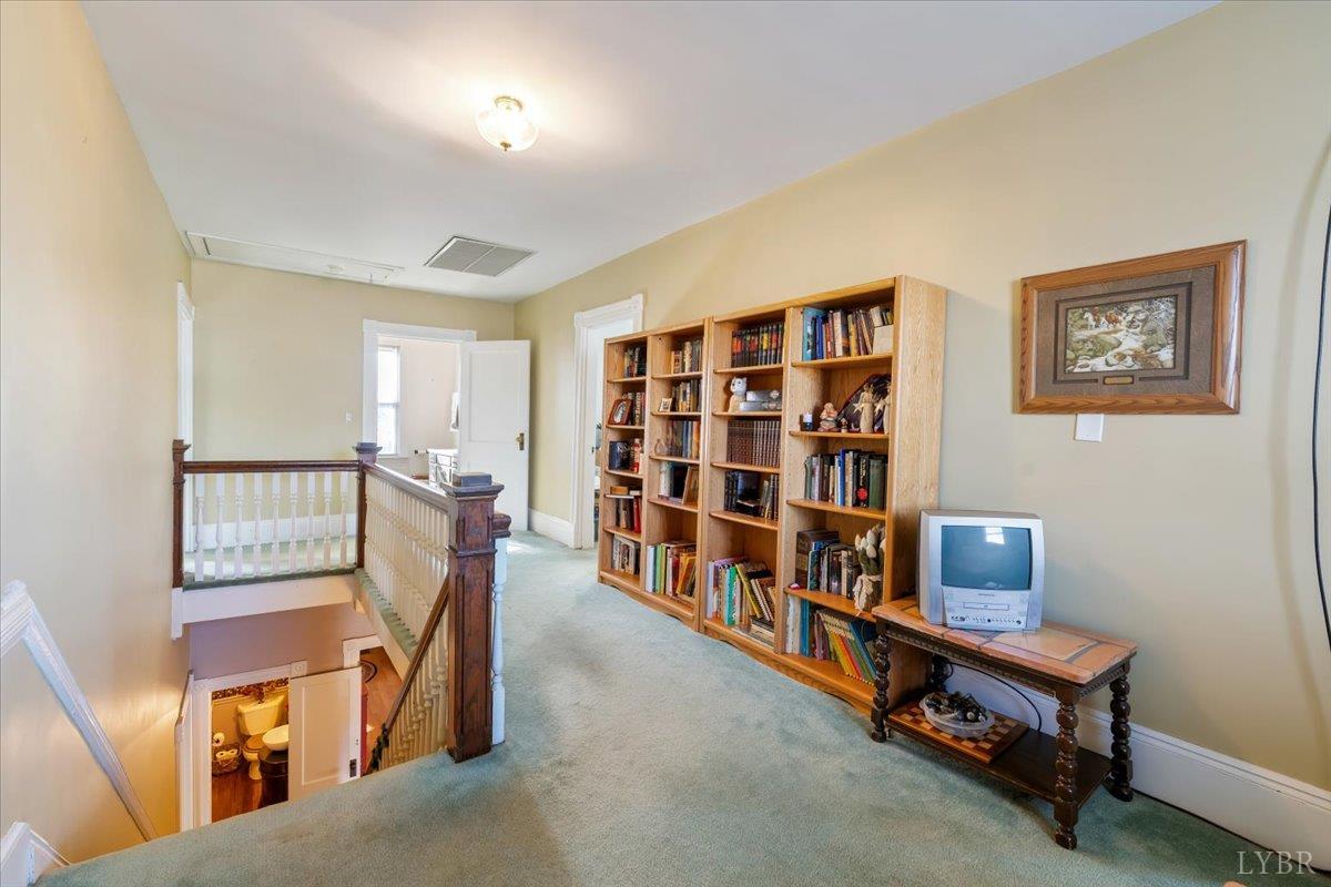 601 Henry Street Gretna, VA 24557 - Photo 26 of 46 a living room with a couch and bookshelf