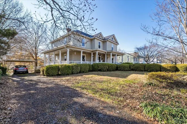 an aerial view of a house with a yard