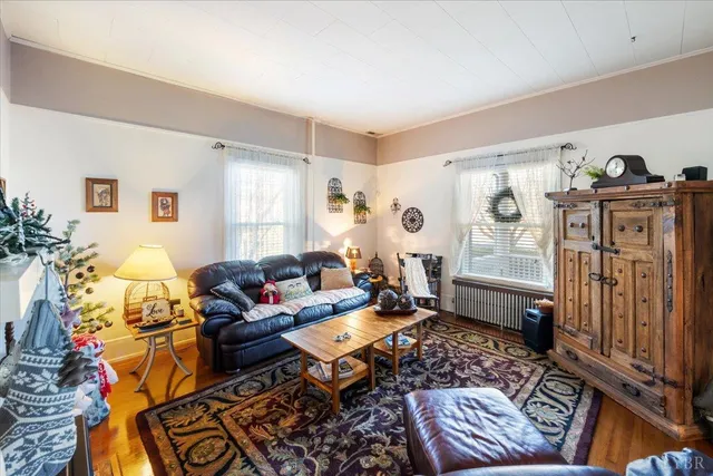 a living room with furniture and wooden floor