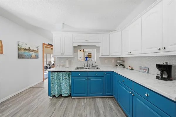 a kitchen with sink and cabinets