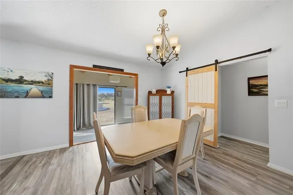 a view of a dining room with furniture and chandelier