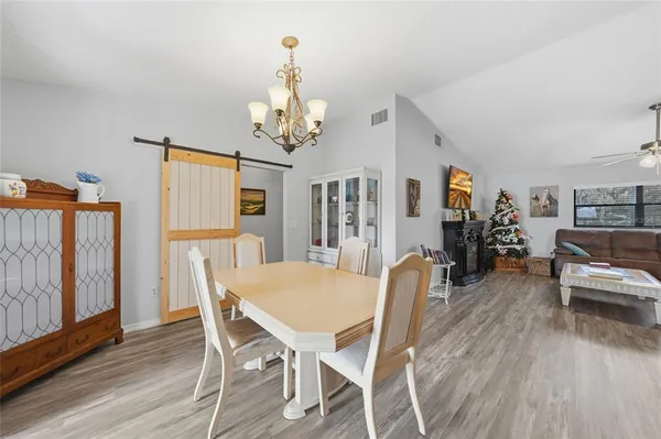 a view of a dining room with furniture and wooden floor