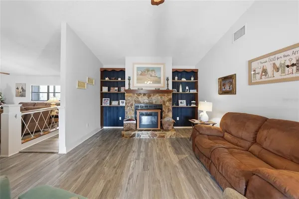 a living room with furniture and a fireplace