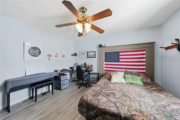 a room with a bed and wooden floor