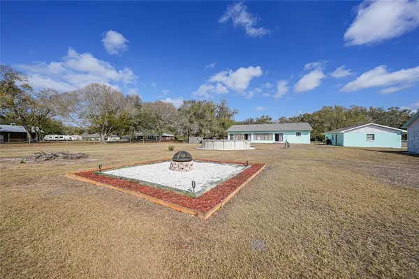 a view of backyard of house and car parked