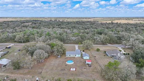 an aerial view of a tennis ground and a mountain view