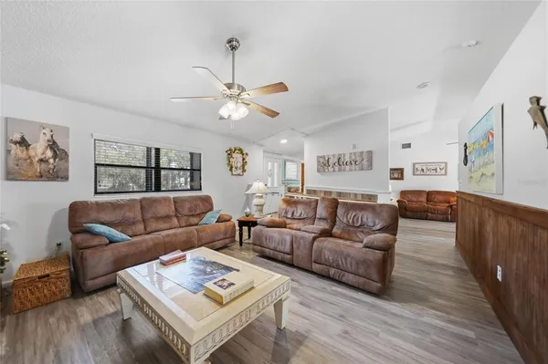 a living room with furniture wooden floor and window