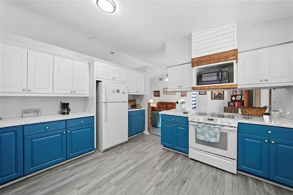 a kitchen with stainless steel appliances granite countertop a stove a sink dishwasher and a refrigerator