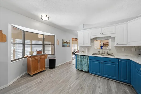 a kitchen with stainless steel appliances wooden floors and wooden cabinets